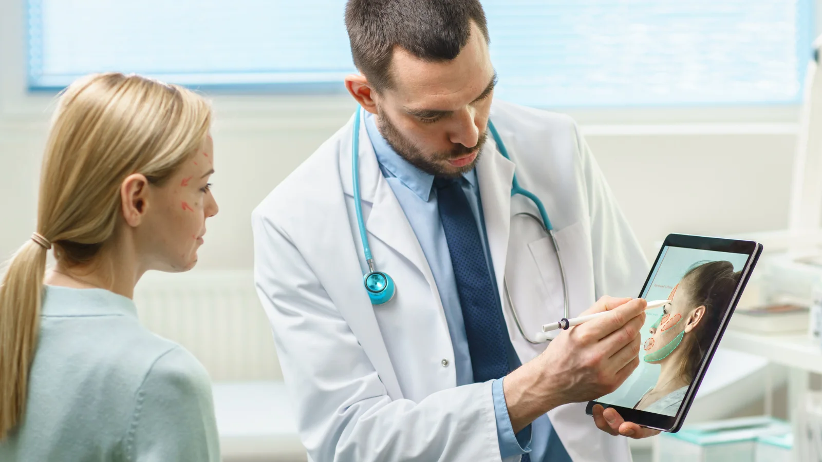 Cosmetic surgery consultation with doctor using tablet